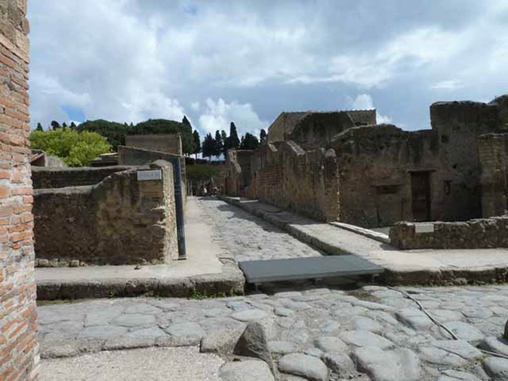 Decumanus inferiore, looking east across junction with Cardo III Superiore on left, and Cardo III Inferiore on right. Ins. VI corner, on left ahead. Corner of Ins. III on right ahead. May 2010.